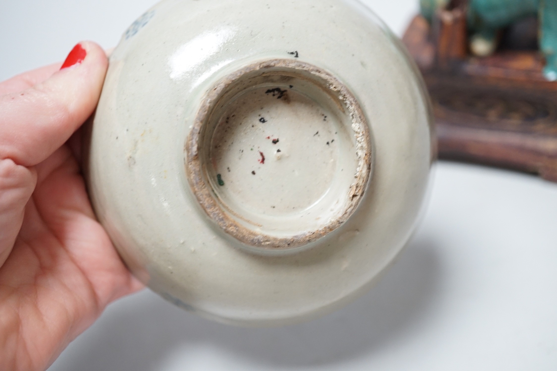 A 19th century Chinese Shiwan figure of a lion-dog and celadon glazed shallow bowl. Tallest 14cm